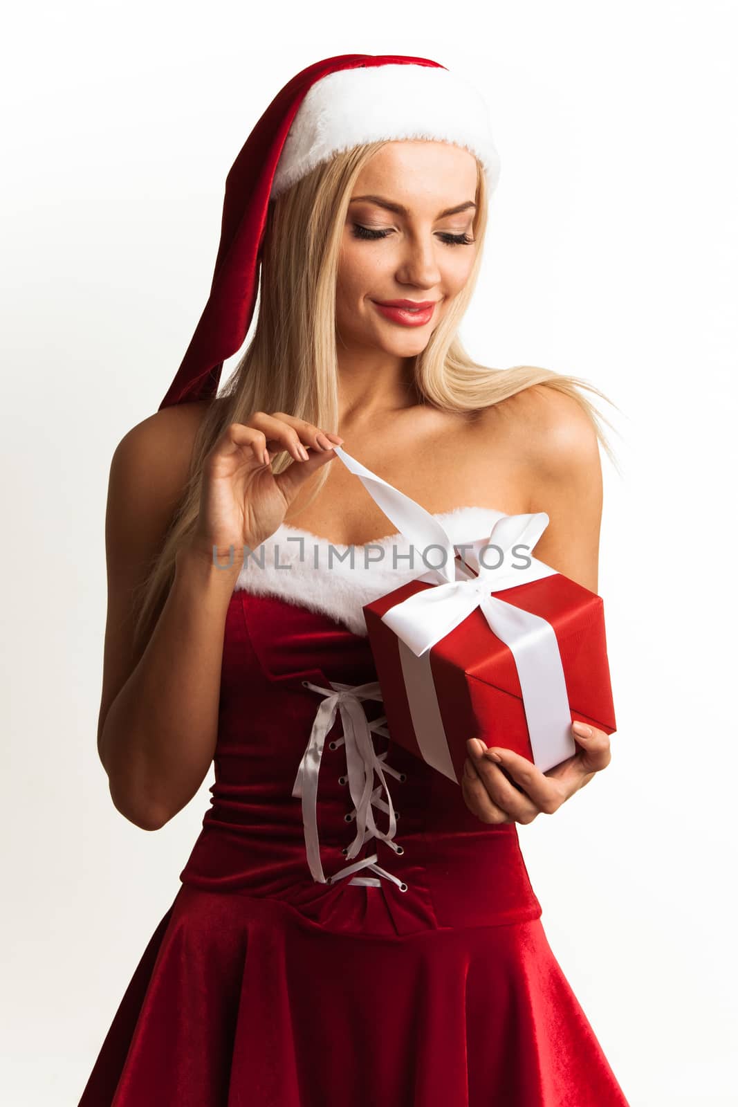 Christmas woman in Santa Claus style dress unpack gift