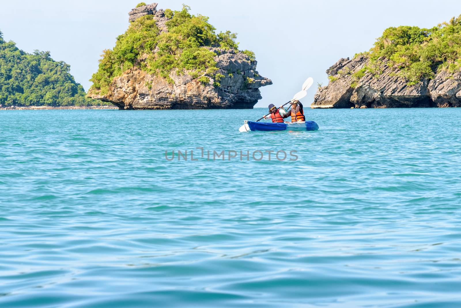 Two women are mother and daughter. Travel by boat with a kayak around island enjoy view the beautiful natural landscape of the blue sea at summer, Mu Ko Ang Thong National Park, Surat Thani, Thailand