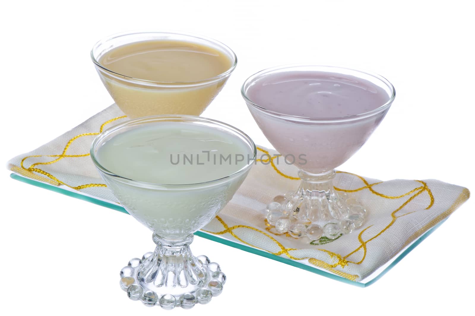 three cups of yogurt in different flavors