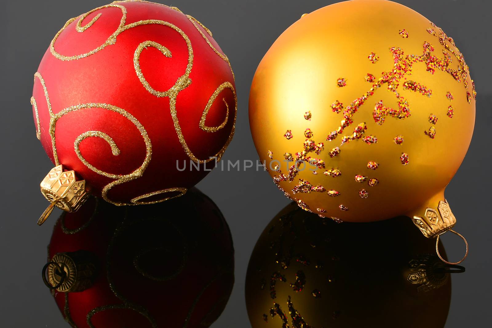 Red and gold christmas balls on black background