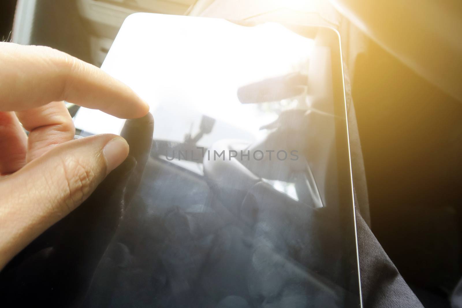 Close-up of female hands using digital tablet computer, hand presses on screen digital tablet with flare light background. Searching Internet ,Social Networking Concept