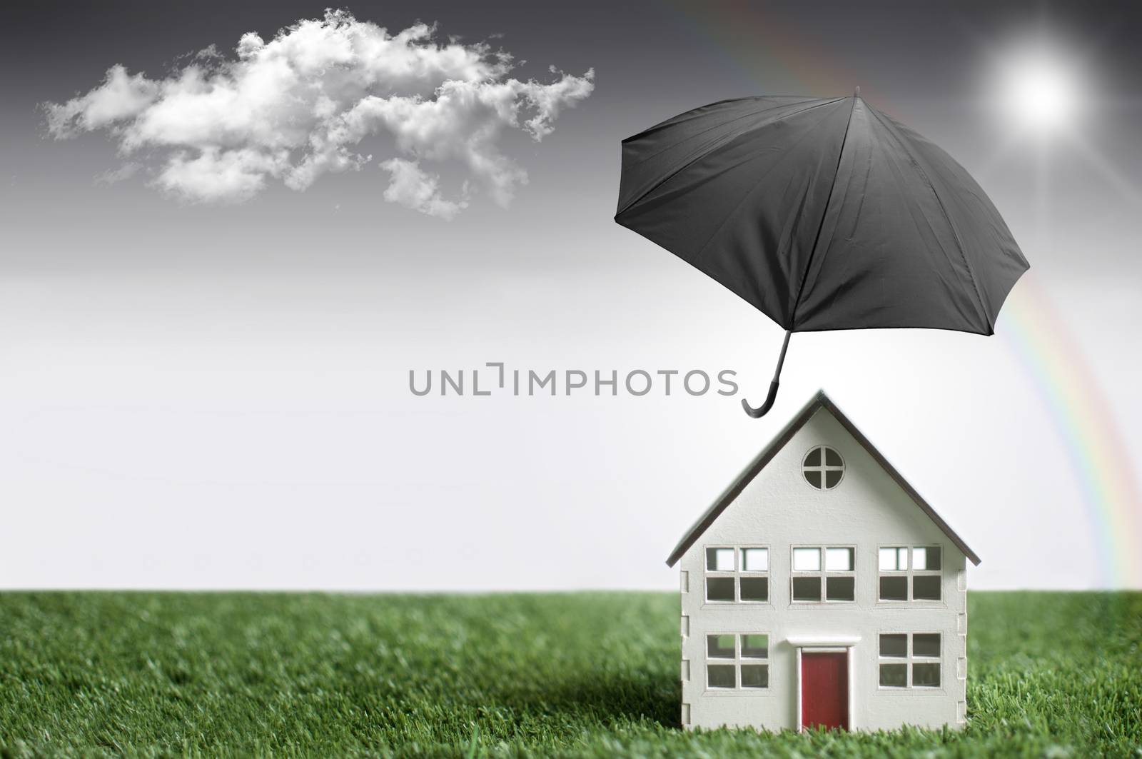 Umbrella protecting a house from bad weather with background space