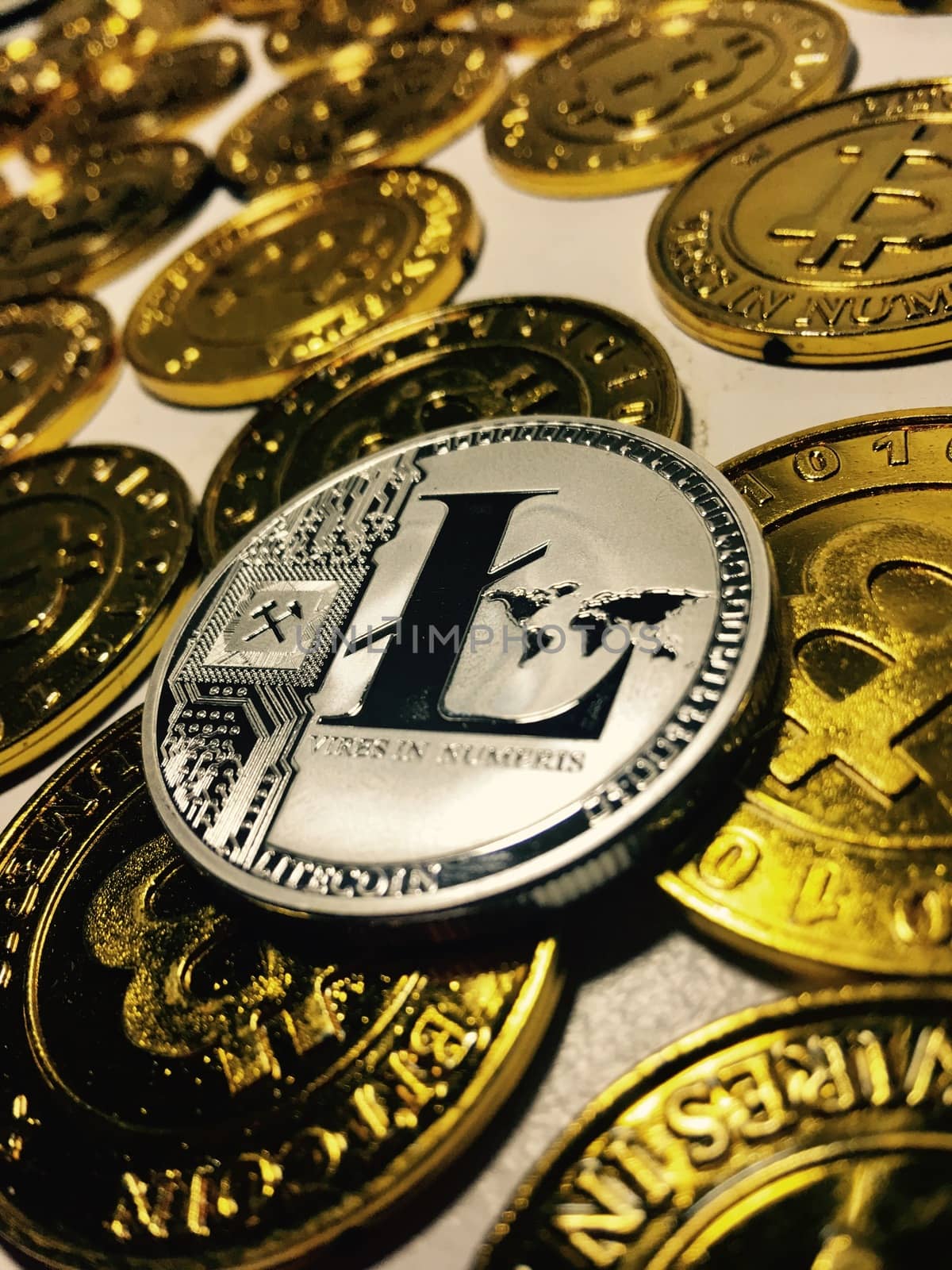 Digital currency physical metal litecoin coin near bitcoin coins. Money concept.