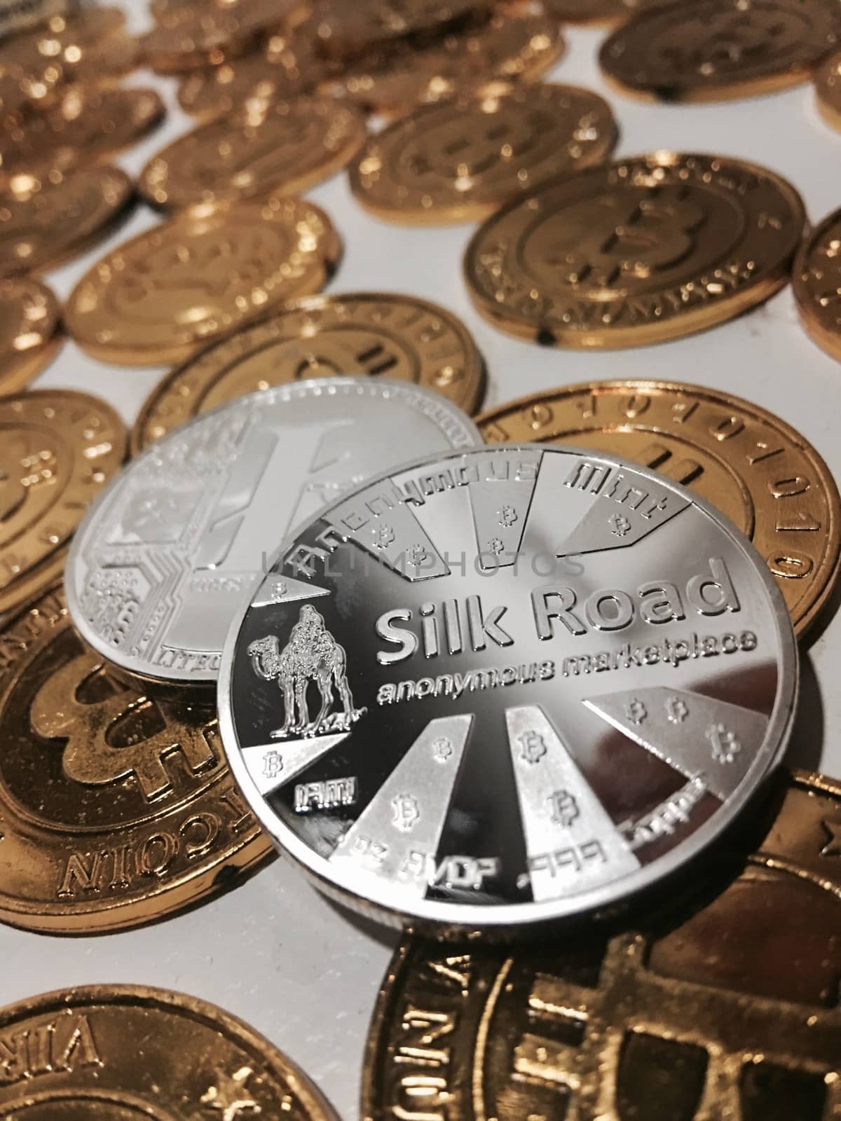 Digital currency physical metal litecoin coin near bitcoin coins. Money concept.