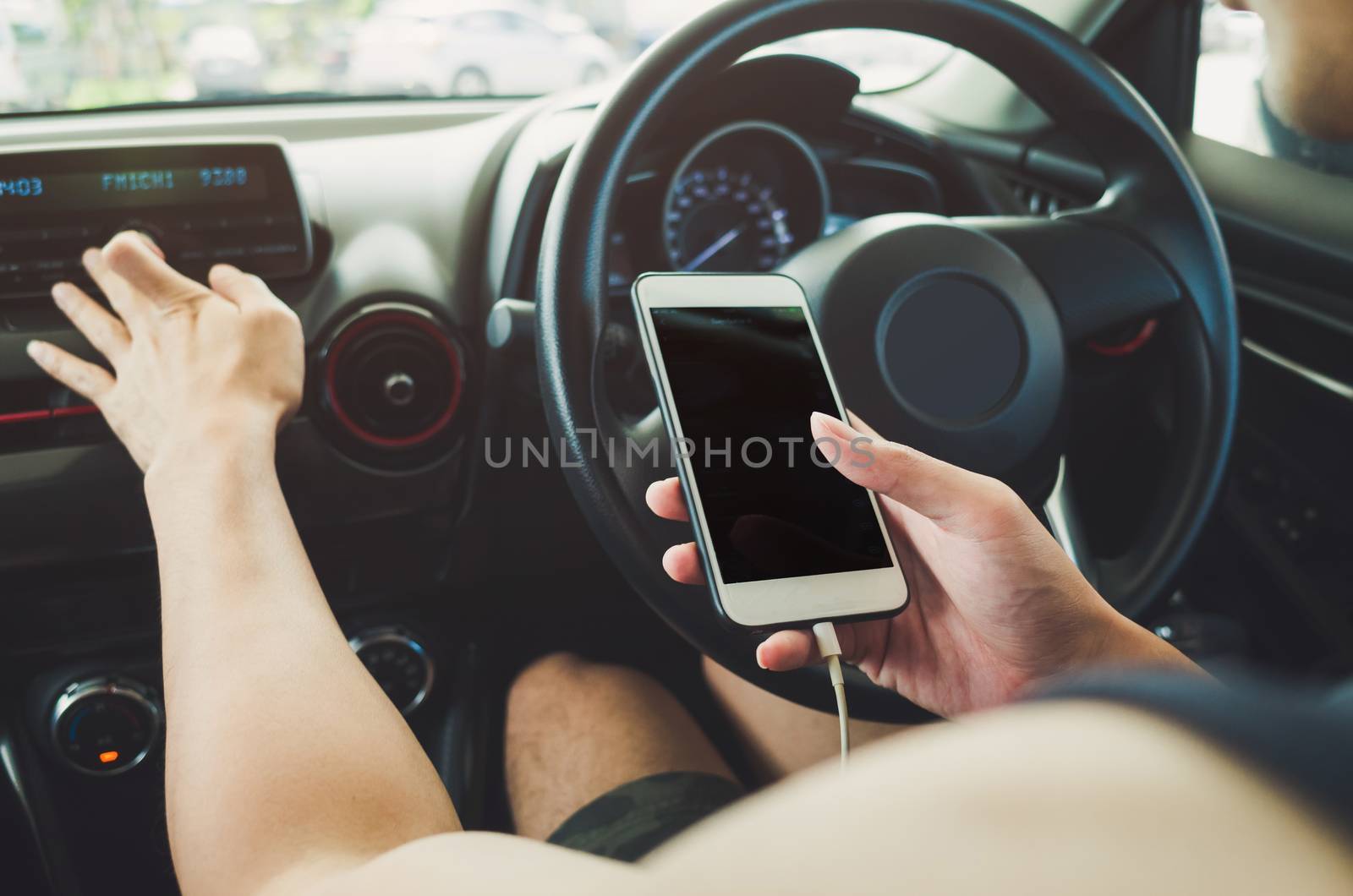 Man using phone in the car by nopparats