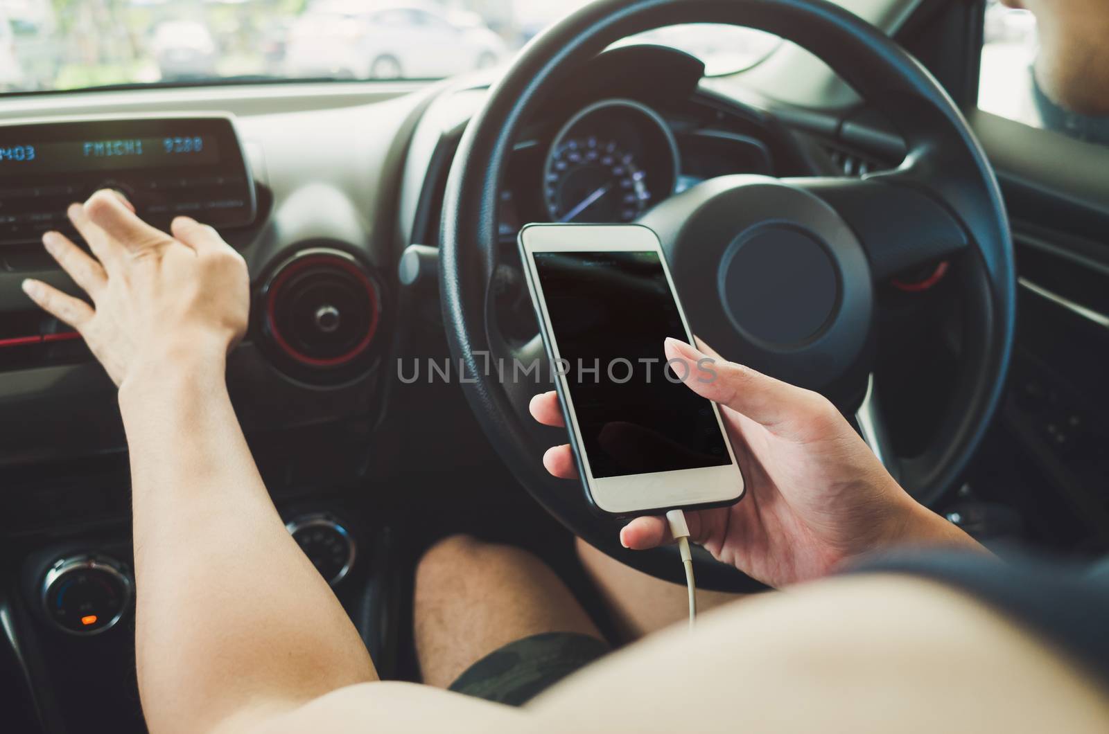 Man using phone in the car.