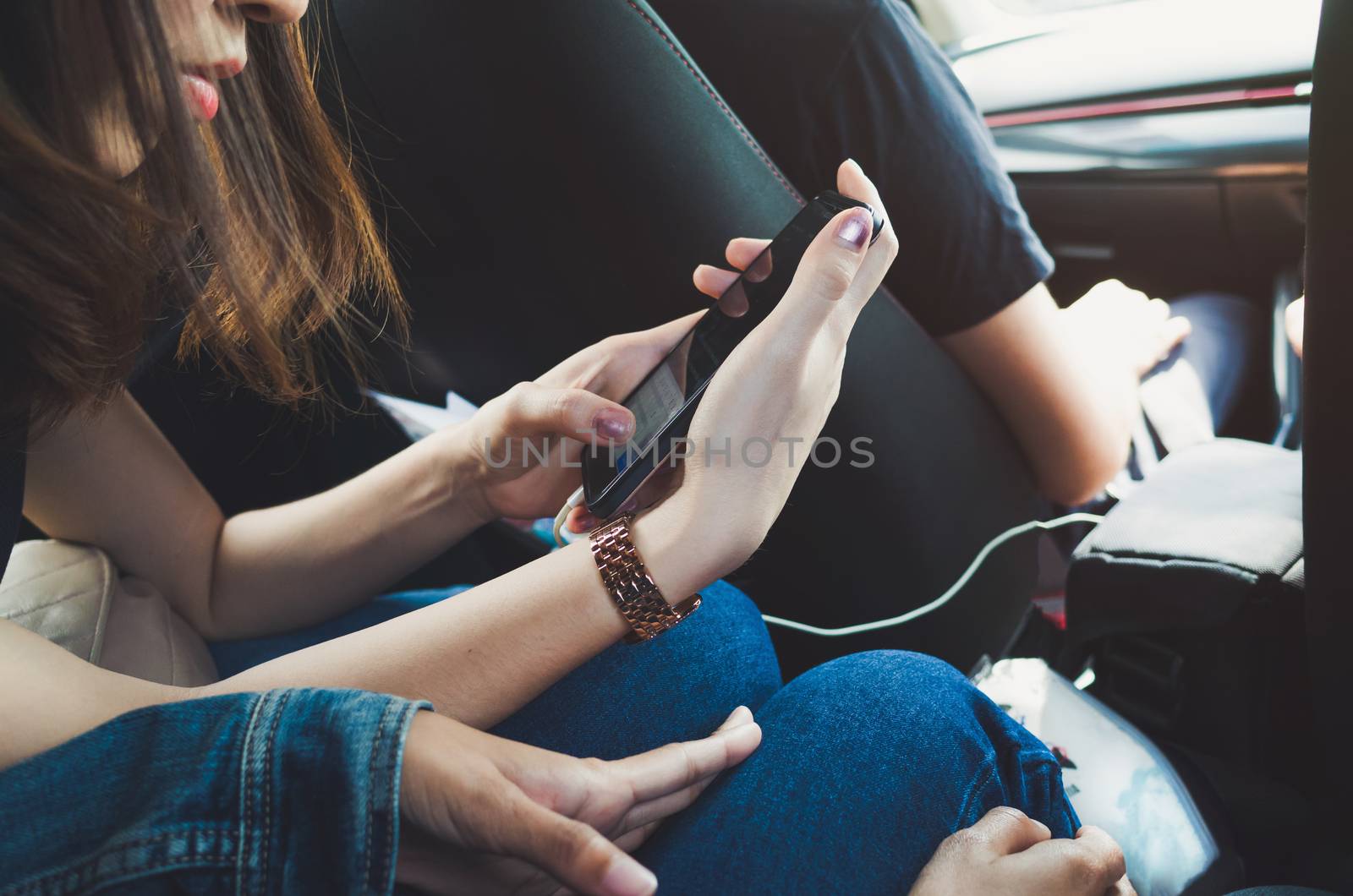 Women using phone in the car.