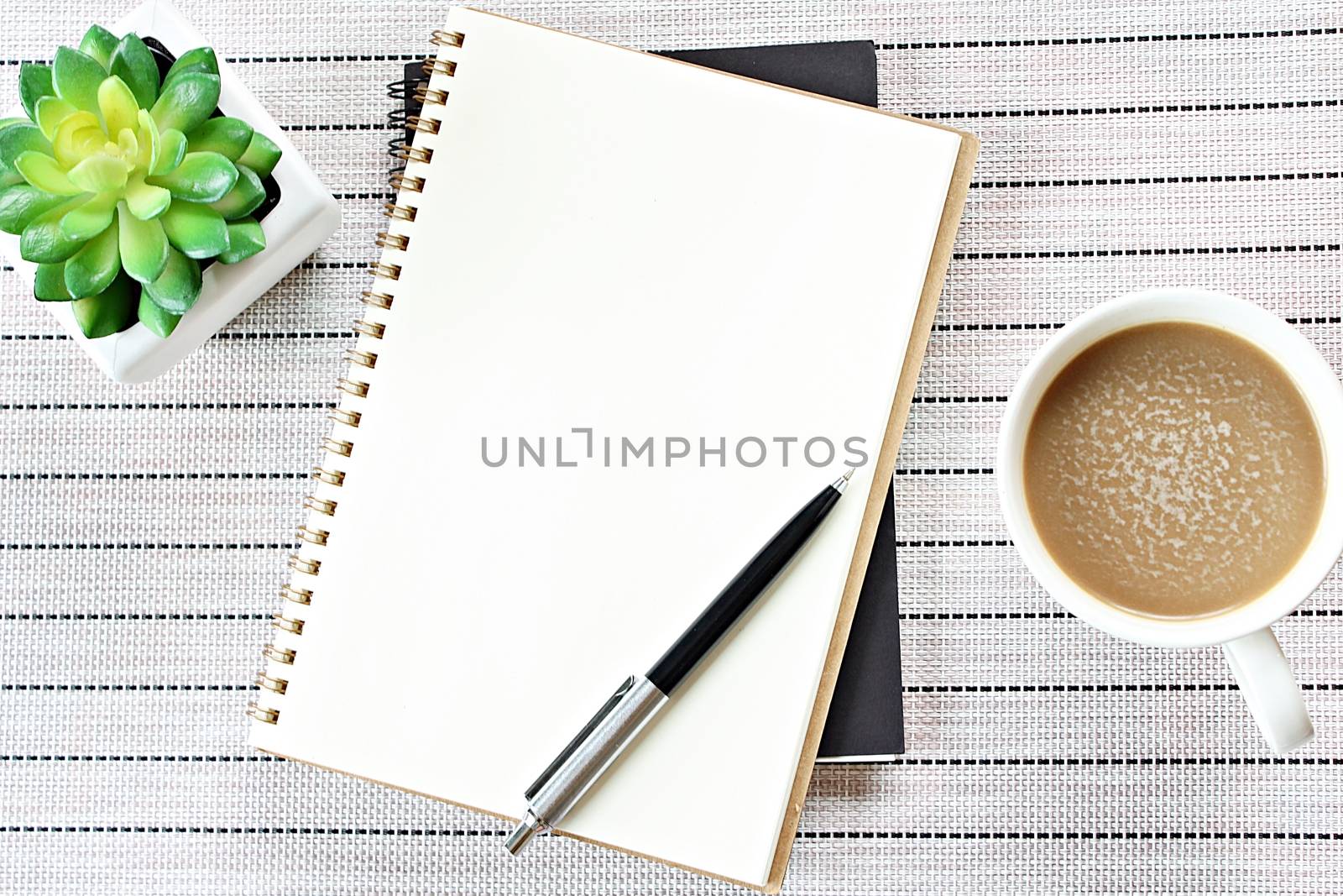 Business, weekend, holiday or new year planning concept : Top view or flat lay of open notebook paper, cube calendar and coffee cup on table background, ready for adding or mock up