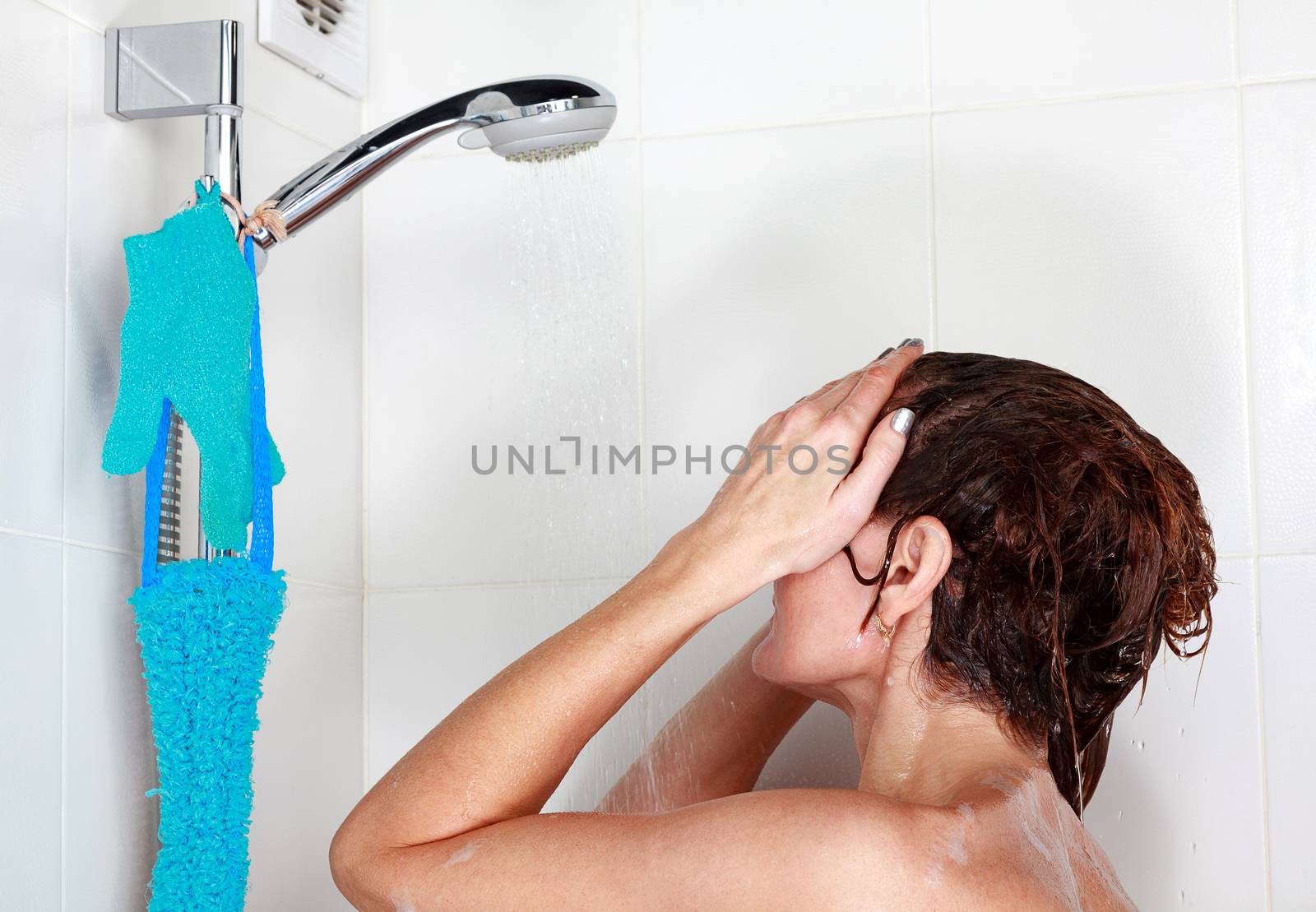 Closeup shot of woman washing her hair in a shower