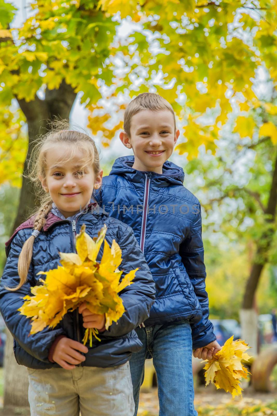 Two children having fun in autumn forest