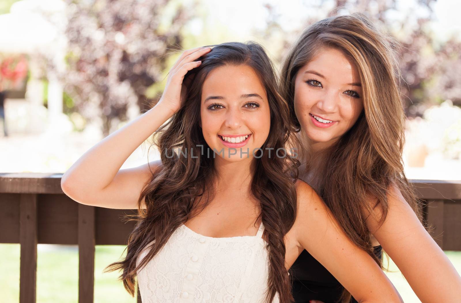 Two Mixed Race Girlfriends Pose for Portrait Outdoors