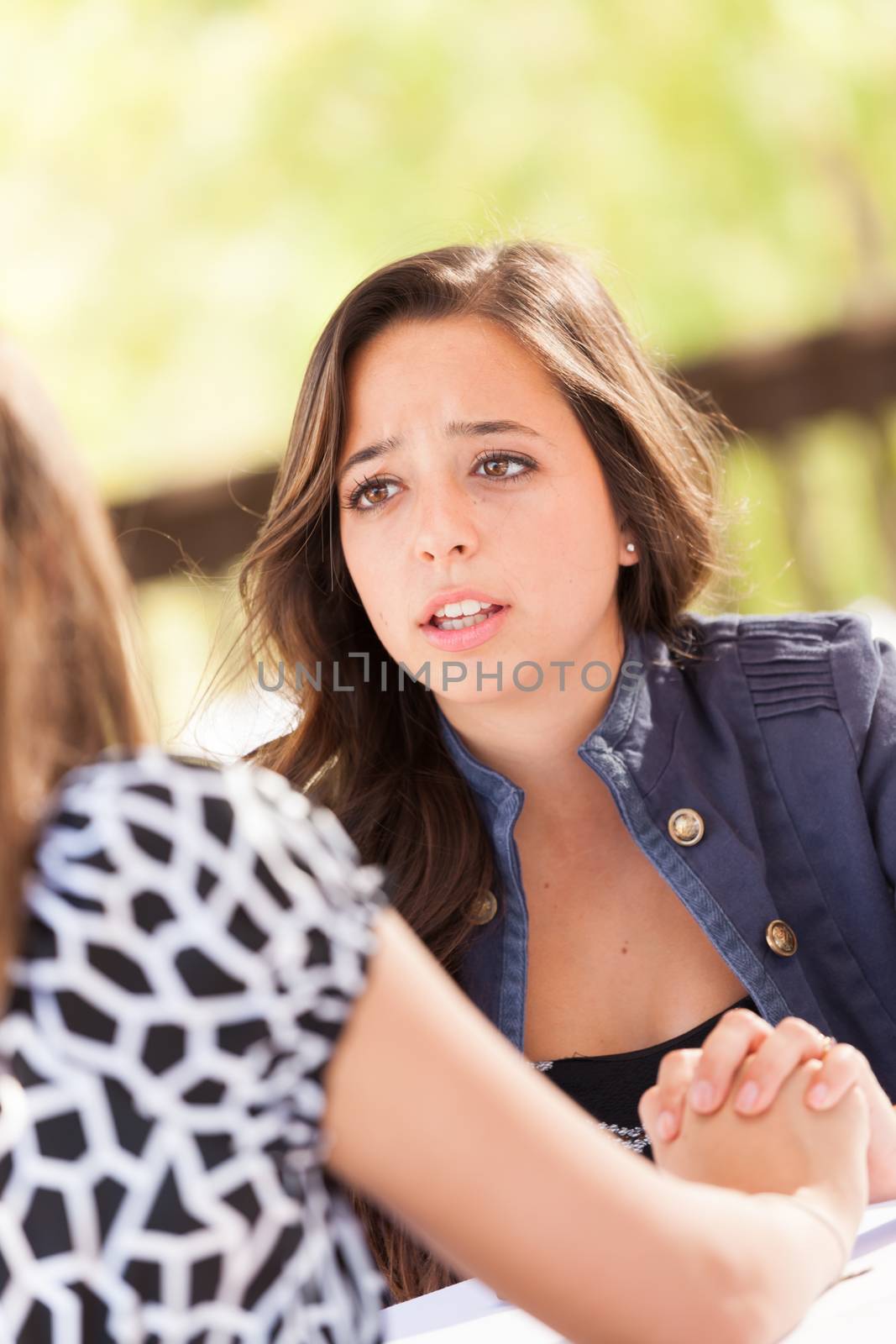 Concerned Young Adult Woman Talking With Her Friend by Feverpitched