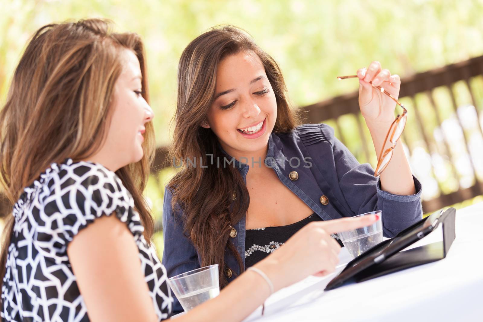 Expressive Young Adult Girlfriends Using Their Computer Electronics Outdoors