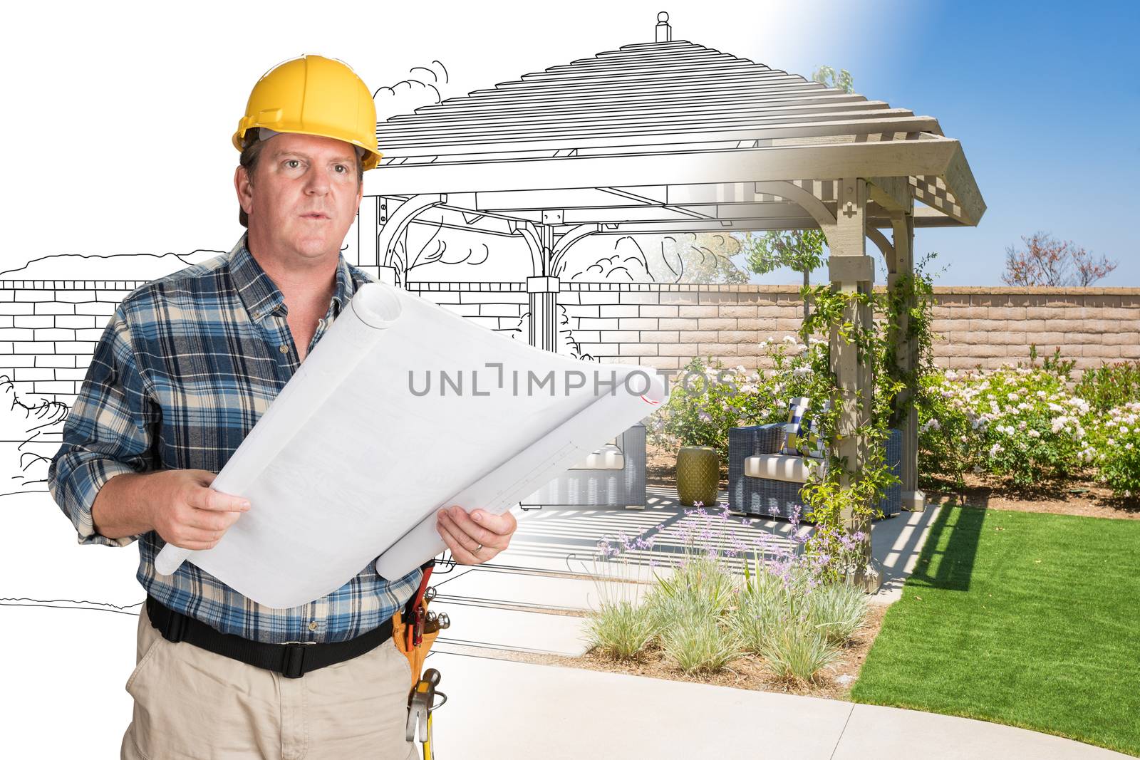 Male Contractor With House Plans Wearing Hard Hat In Front of Custom Pergola Patio Covering Drawing Photo Combination