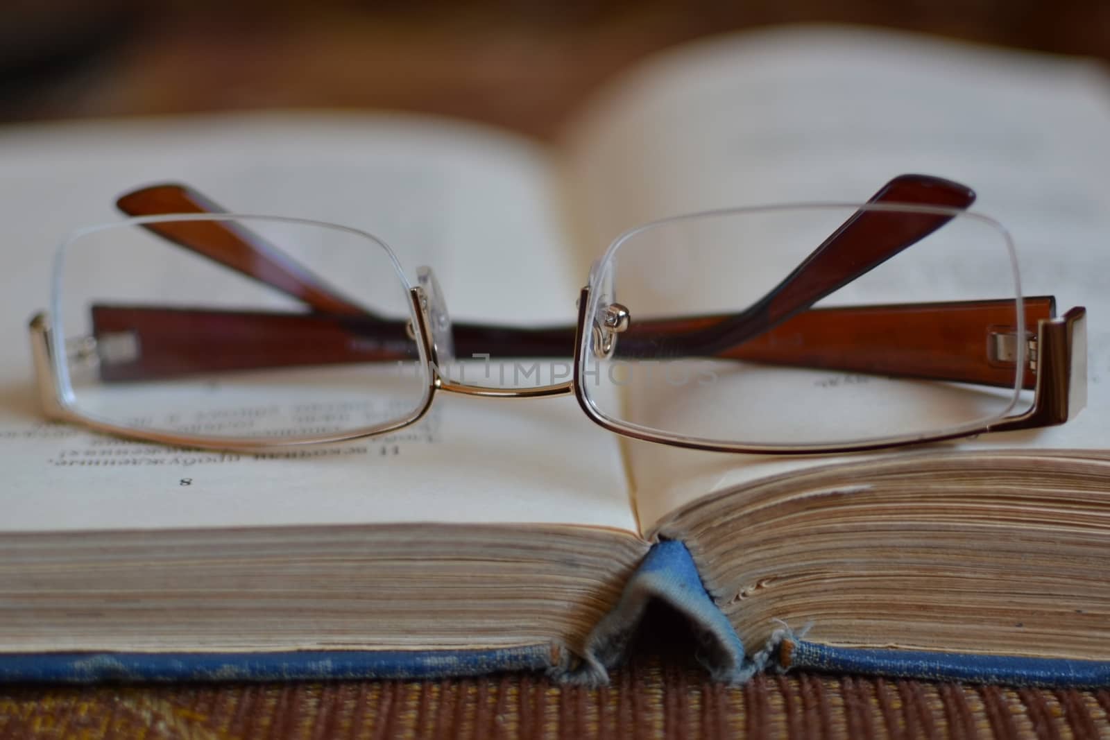 glasses lying on an open book