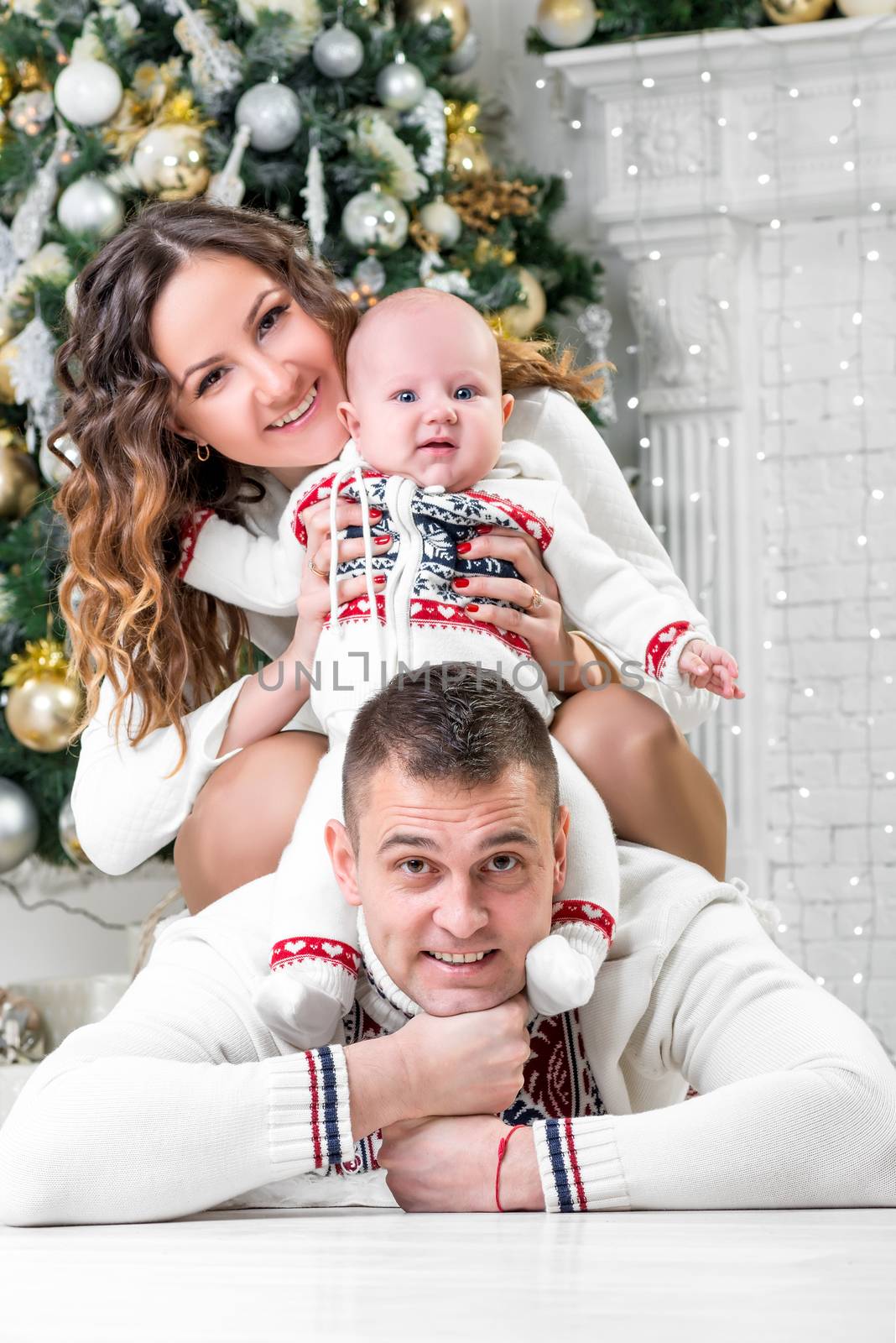 happy young family with son near Christmas fir-tree pose by kosmsos111