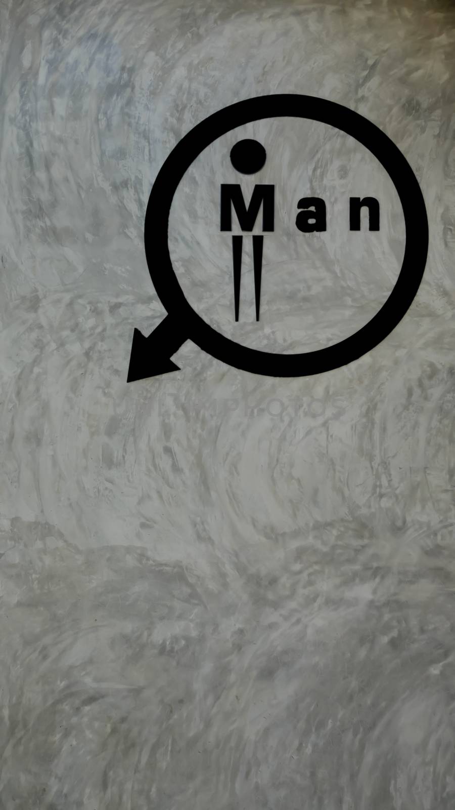 Black toilet logo on the background of gray cement walls