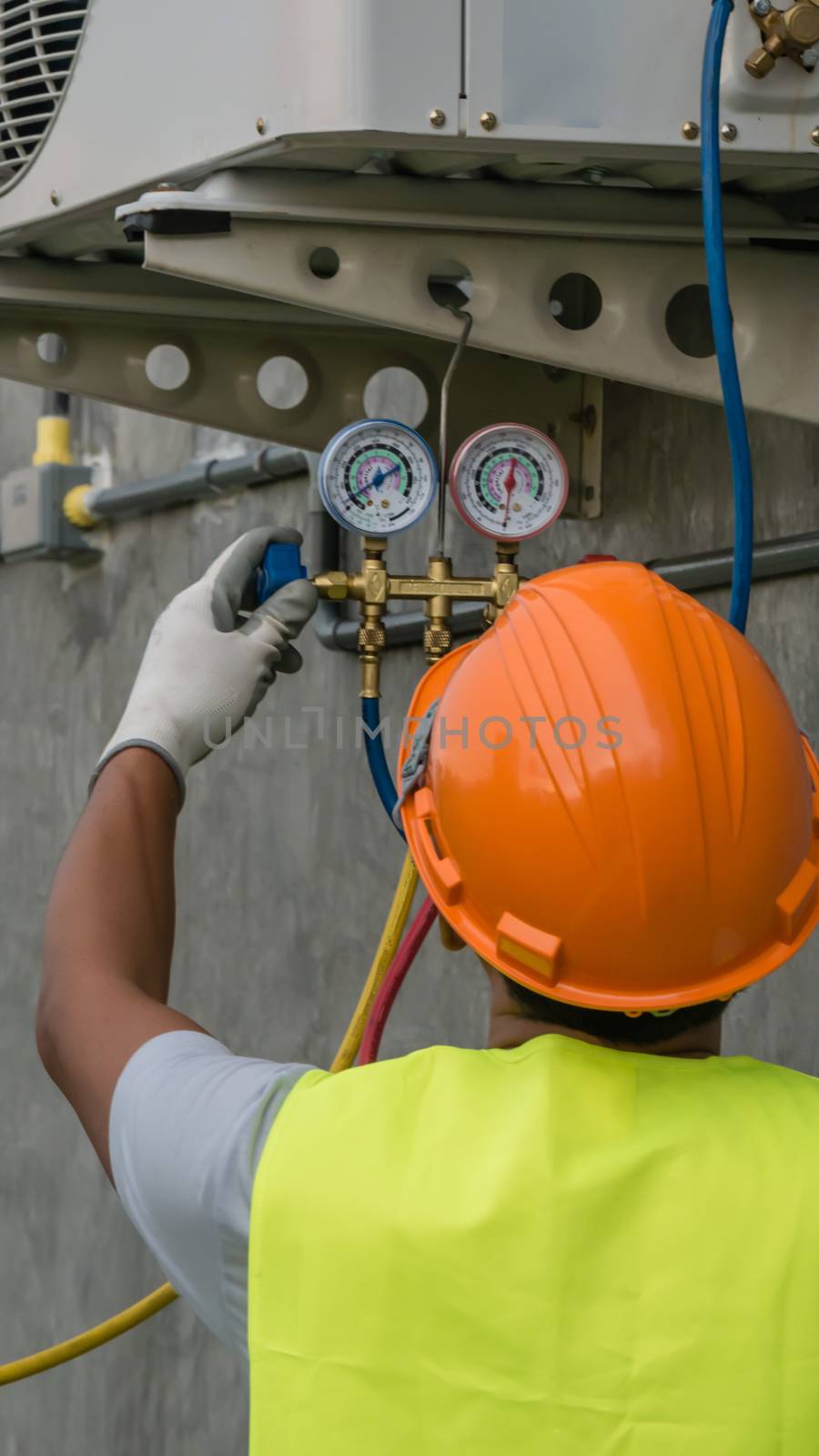 Technician is checking air conditioner  by rakratchada