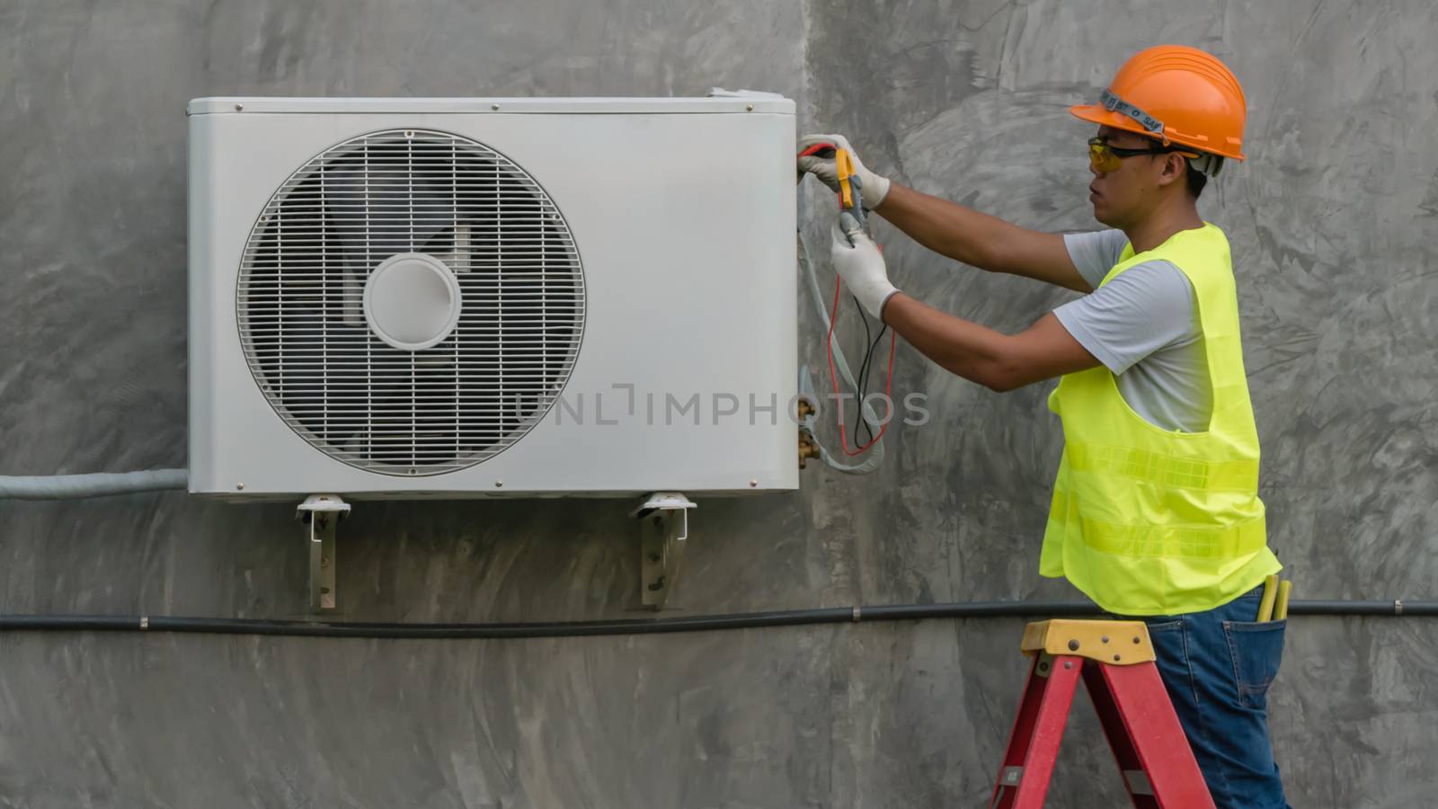 Technician is checking air conditioner  by rakratchada