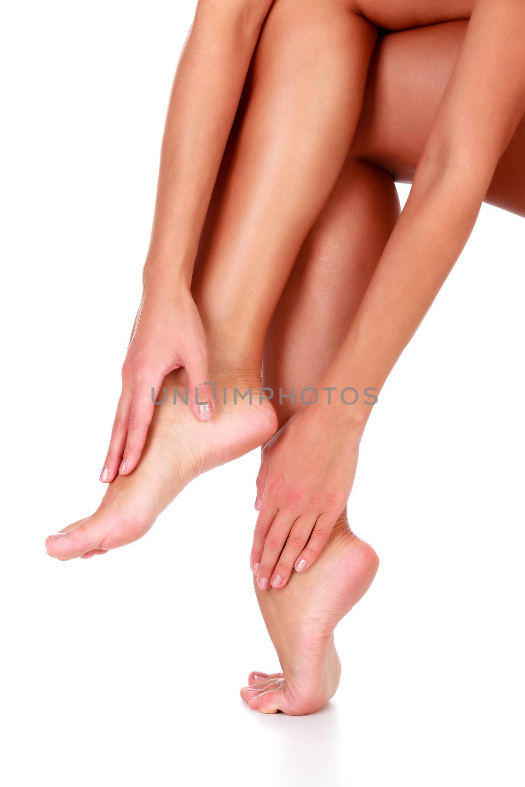 Closeup shot of healthy legs of beautiful woman, isolated on white background