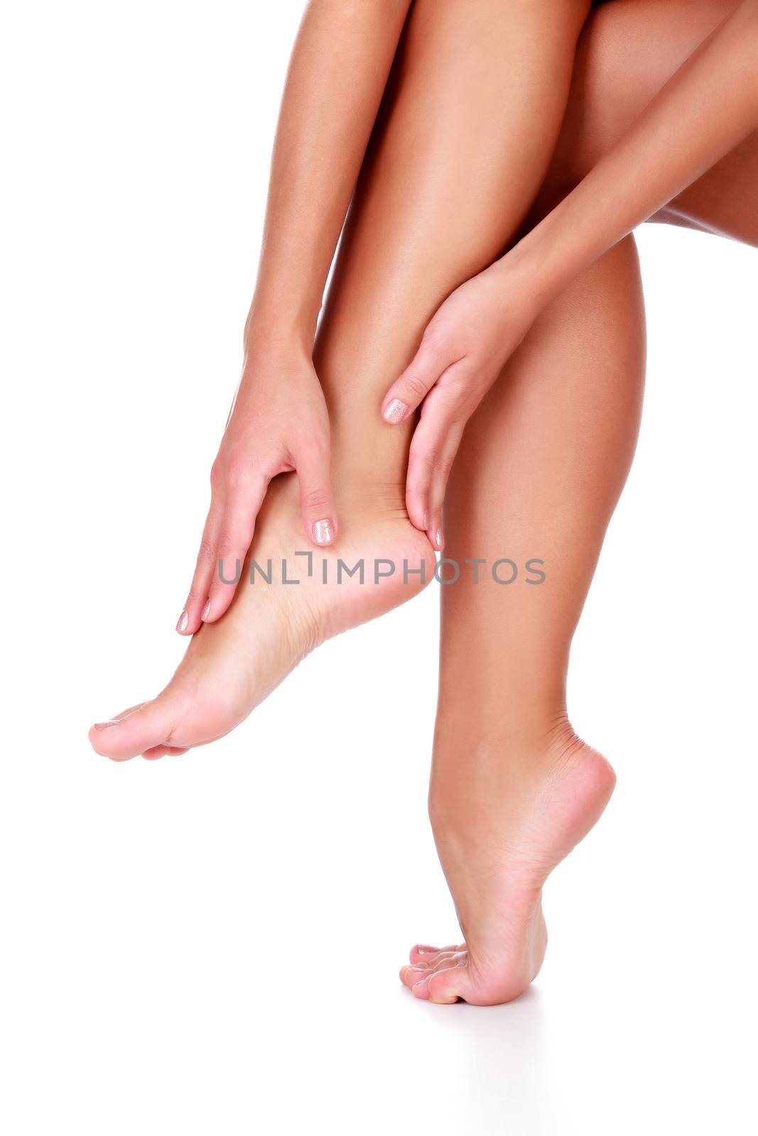 Closeup shot of healthy legs of beautiful woman, isolated on whi by Nobilior