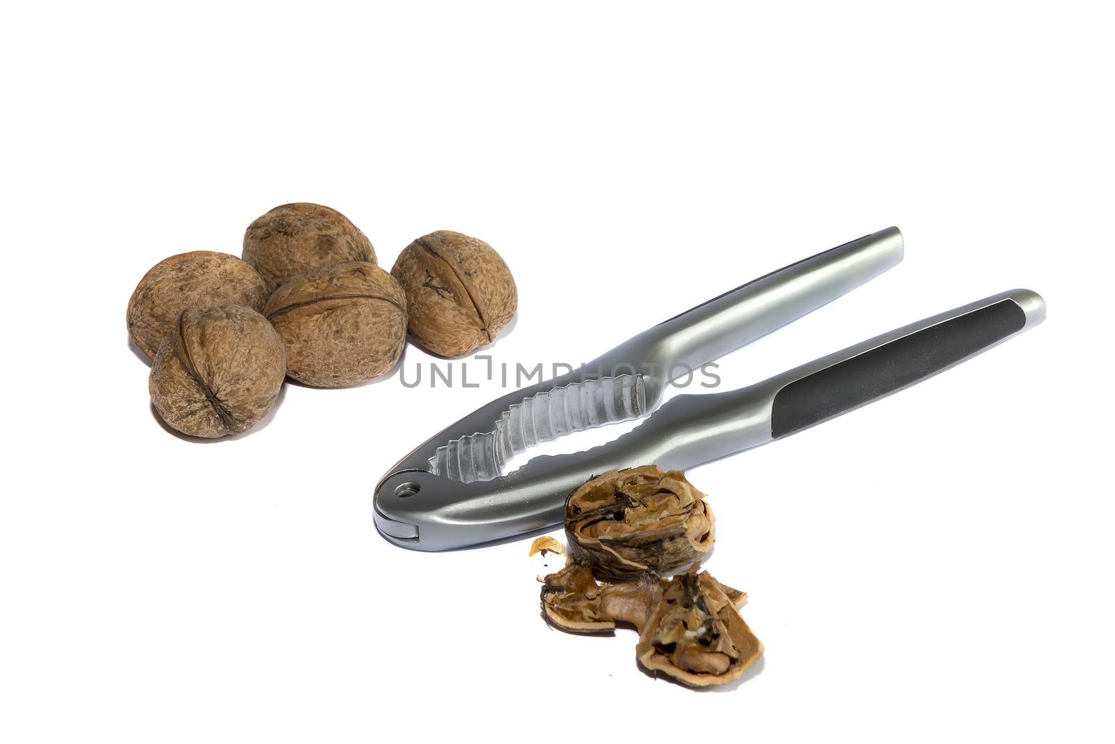 Group of walnuts and broken walnuts with a Nutcracker, isolated  on white background