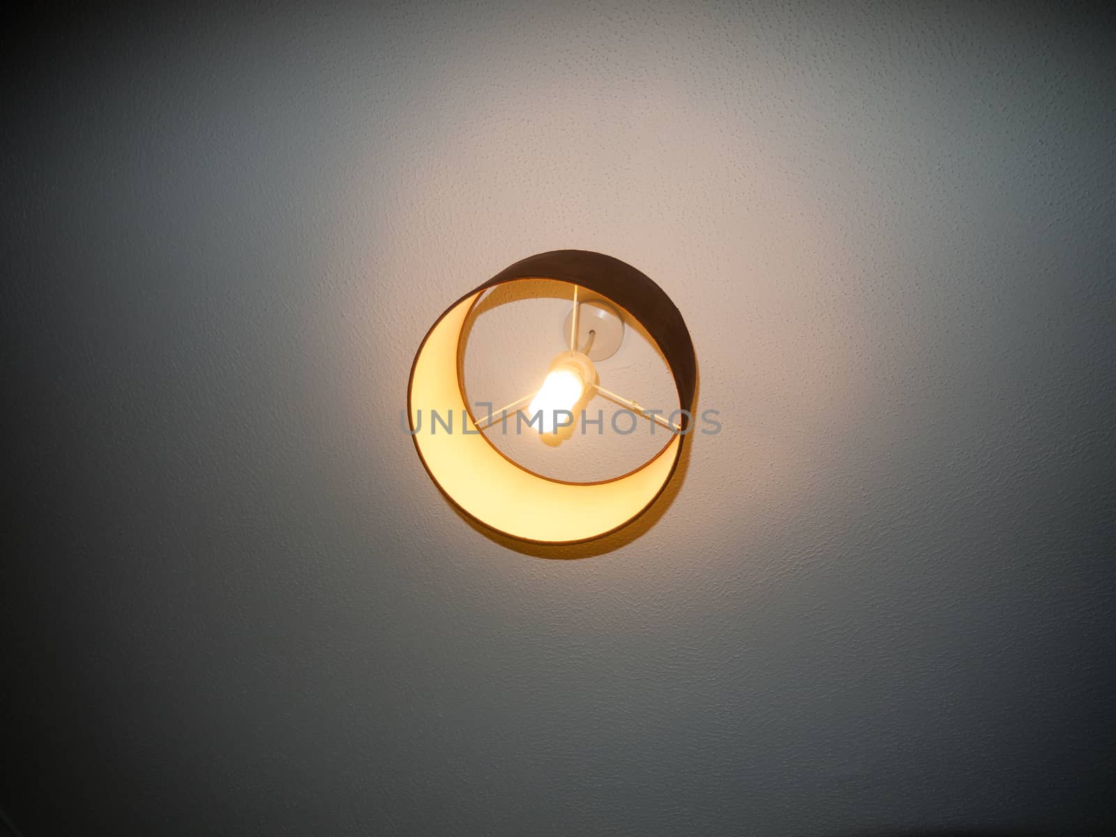 bedroom ceiling light turned on electricity white bright; essex; england; uk