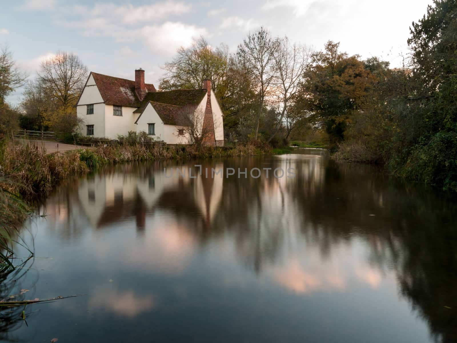 beautiful willy lotts cottage autumn long exposure blurred water constable country flatford mill; suffolk; england; uk