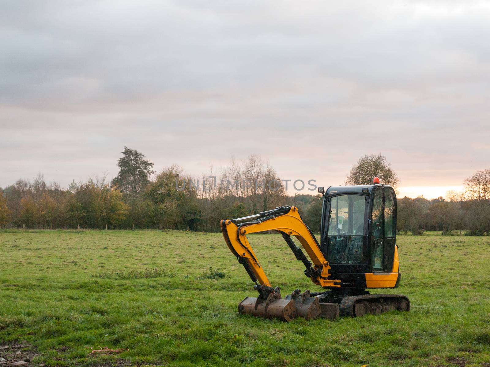 industry construction environment yellow digger machine parked outside country autumn; essex; england; uk