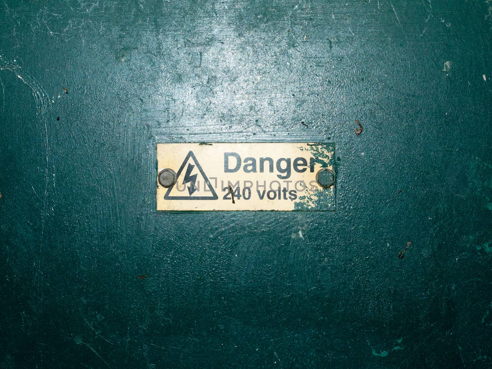 bunch of safety signs water green box yellow triangle; essex; england; uk; danger 220 volts