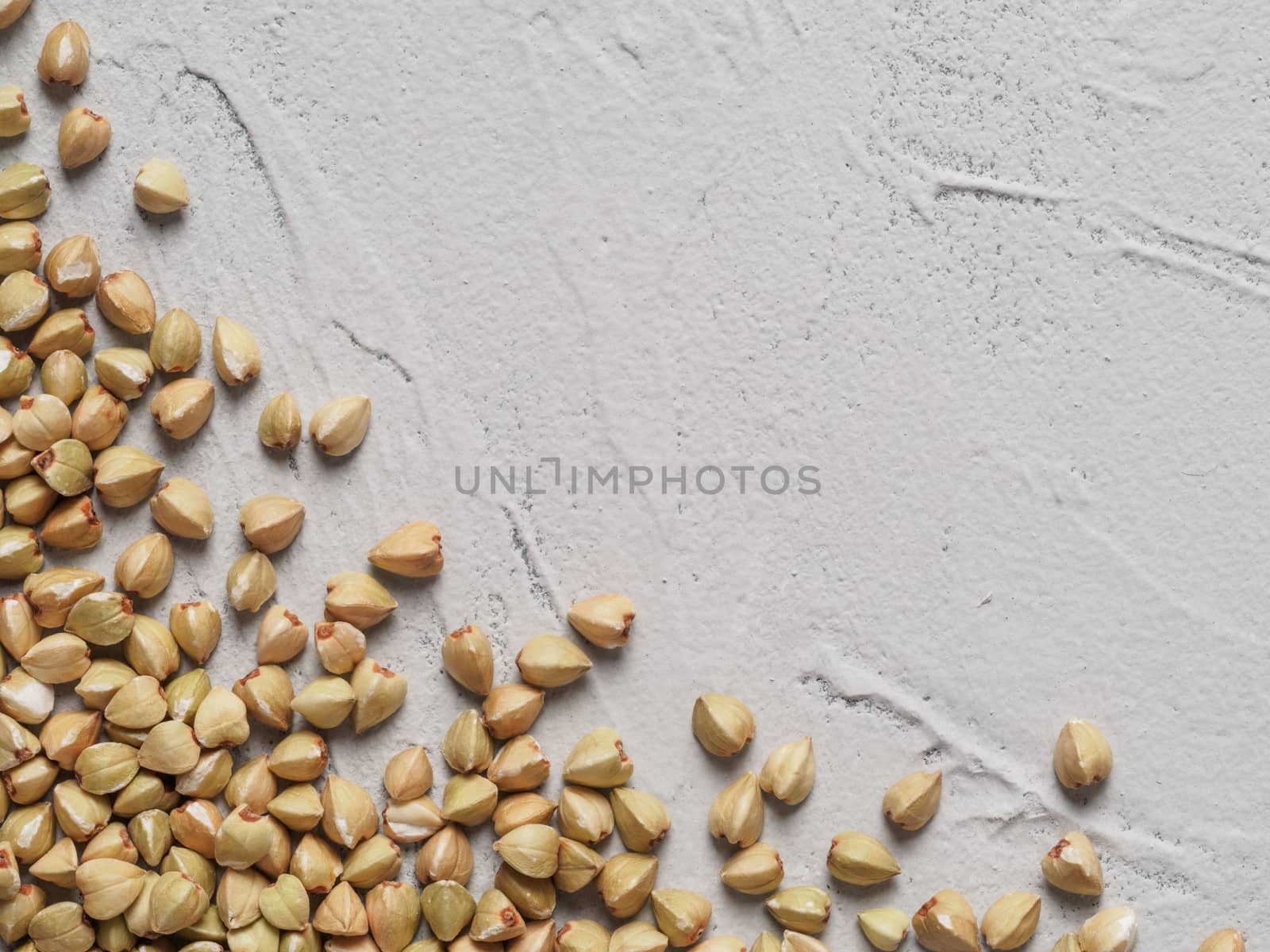 Raw green buckwheat on gray concrete background Healthy food and diet concept. Top view or flat lay