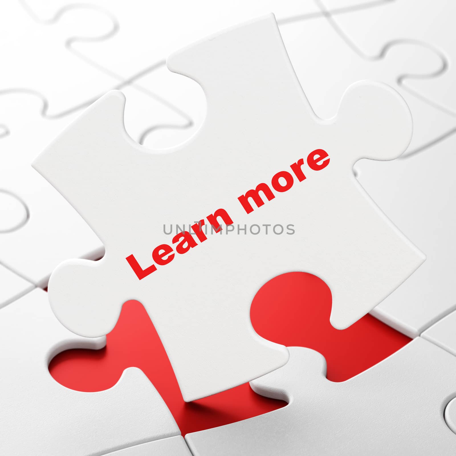 Learning concept: Learn More on White puzzle pieces background, 3D rendering