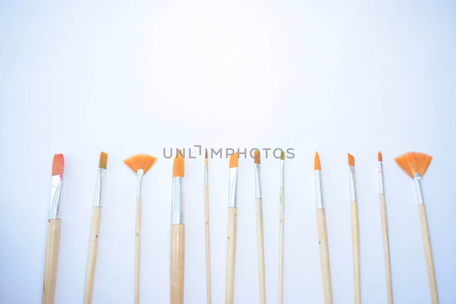 artist Paint brushes on a plain background with space