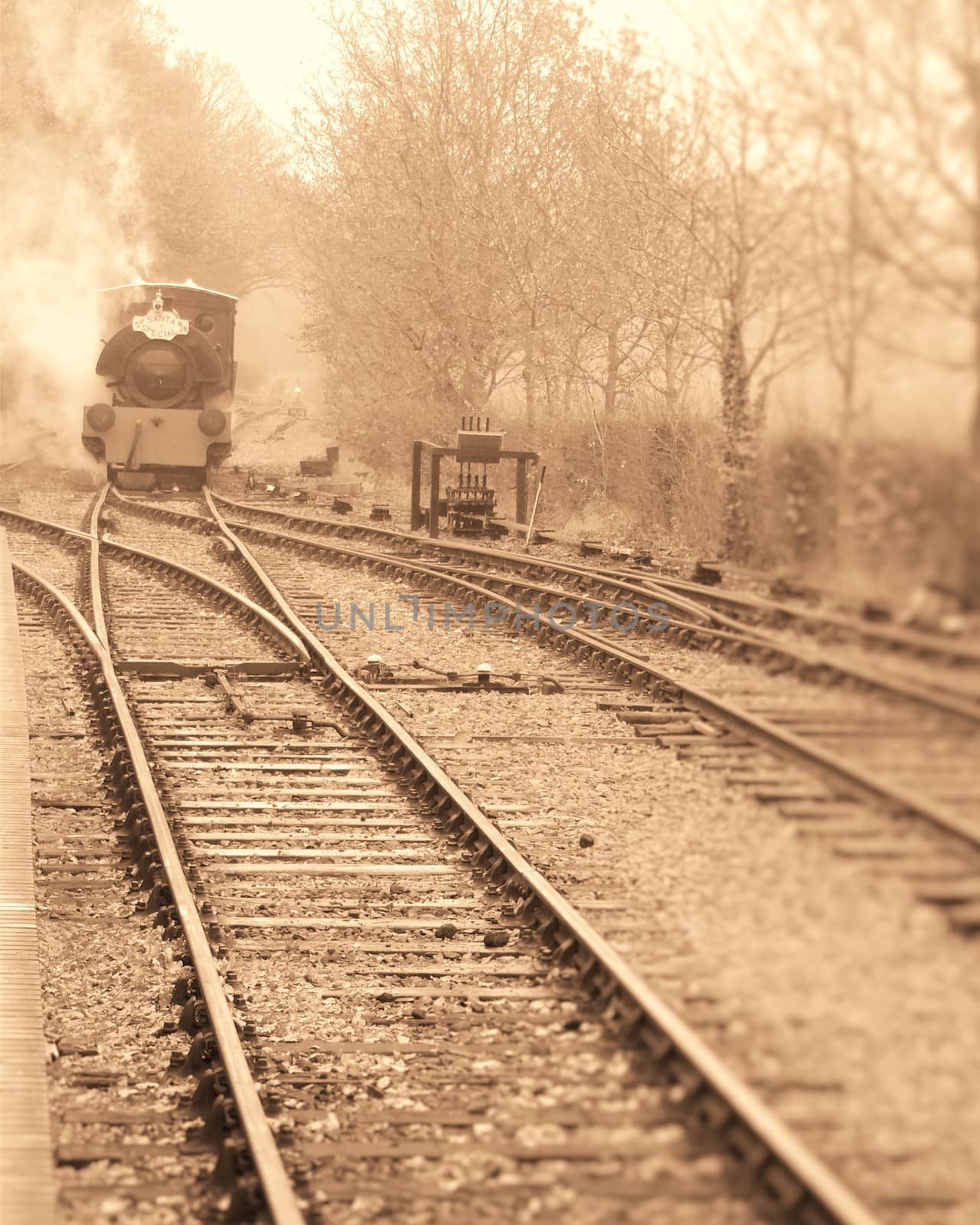 steam engine approaching station along tracks