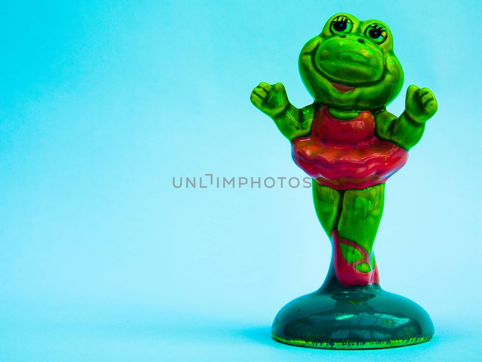 Bright green frog in a tutu doing ballet 