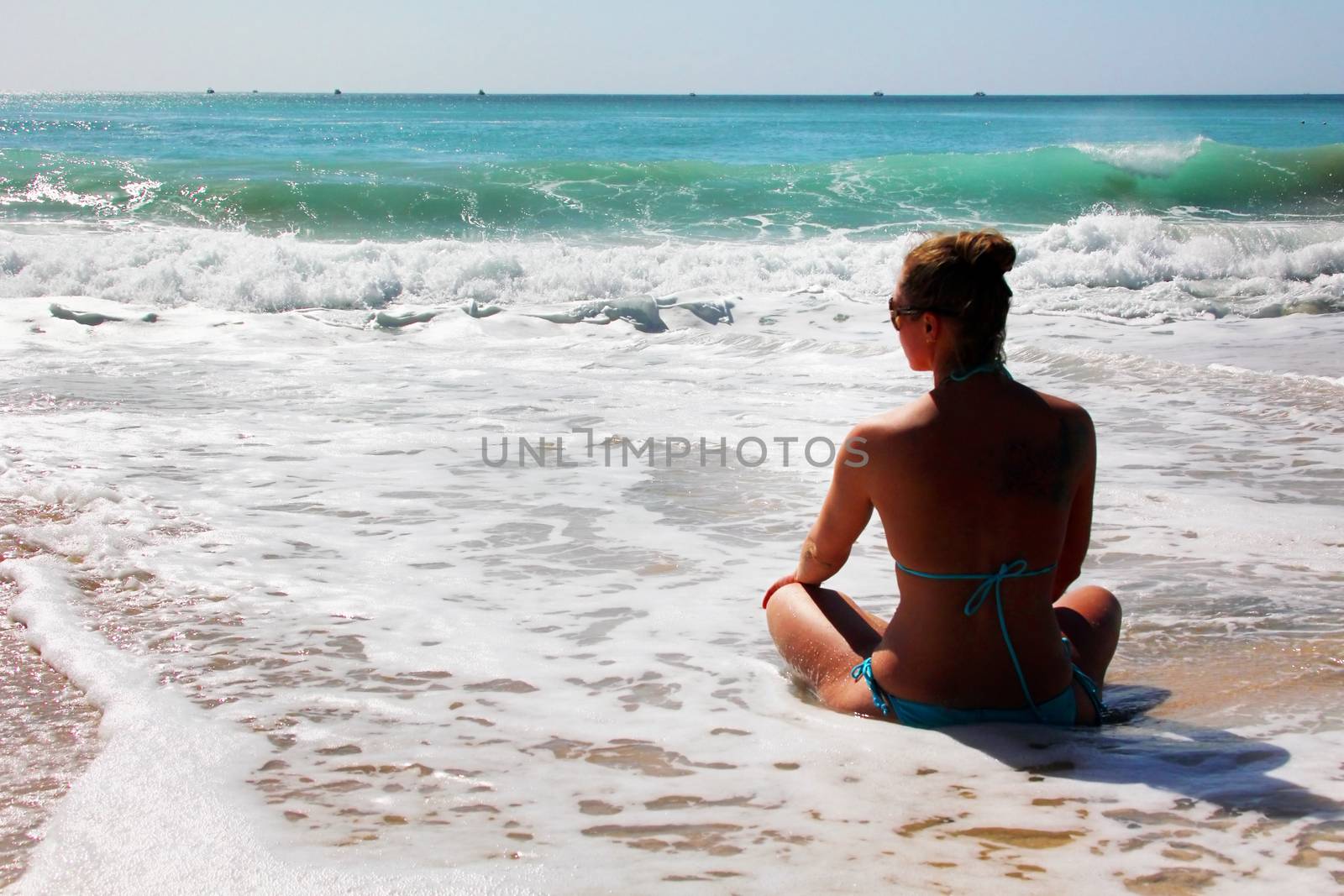 The girl is meditating on the ocean shore. Bali