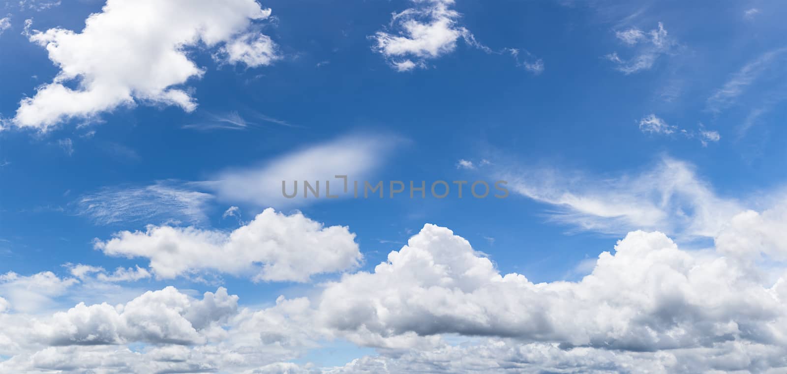 Panoramic white fluffy clouds in the blue sky, Fantastic soft white clouds against blue sky