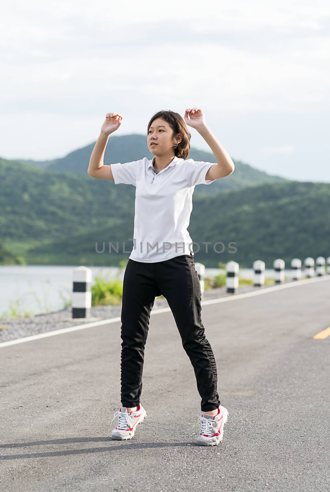 Woman short hair doing exercising outdoor by stoonn