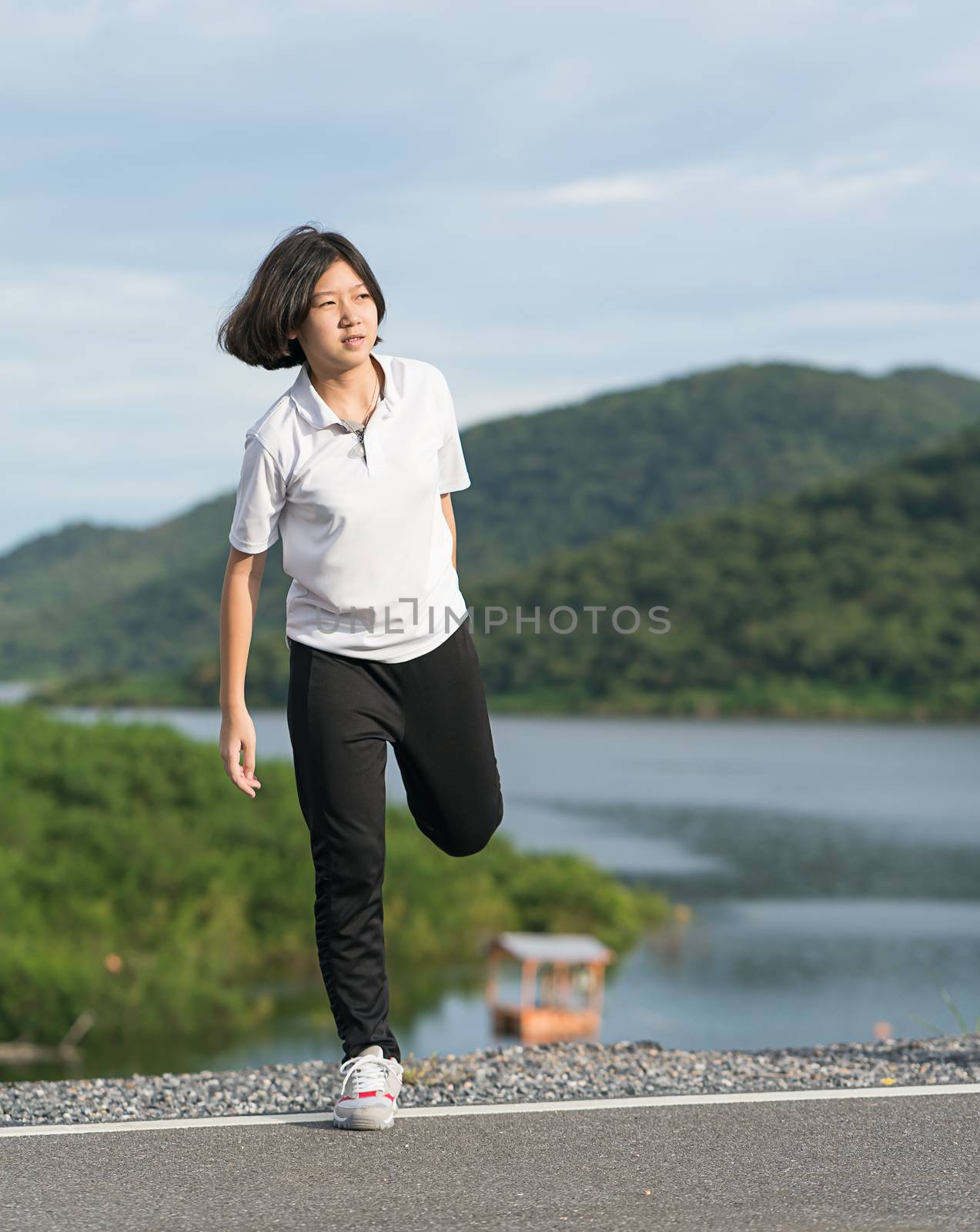 Woman short hair doing exercising outdoor by stoonn