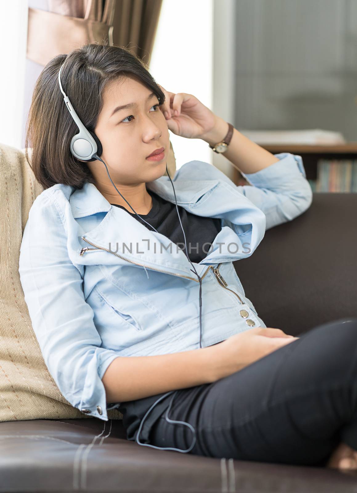Woman short hair listening music in living room by stoonn