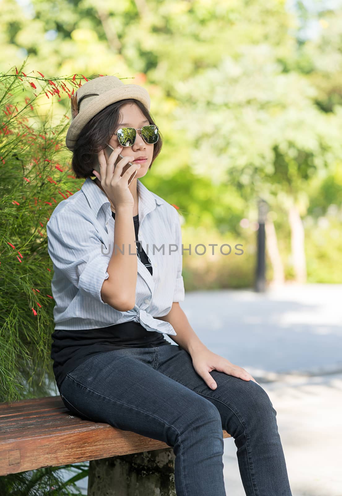 Women with short hair wearing hat in garden by stoonn