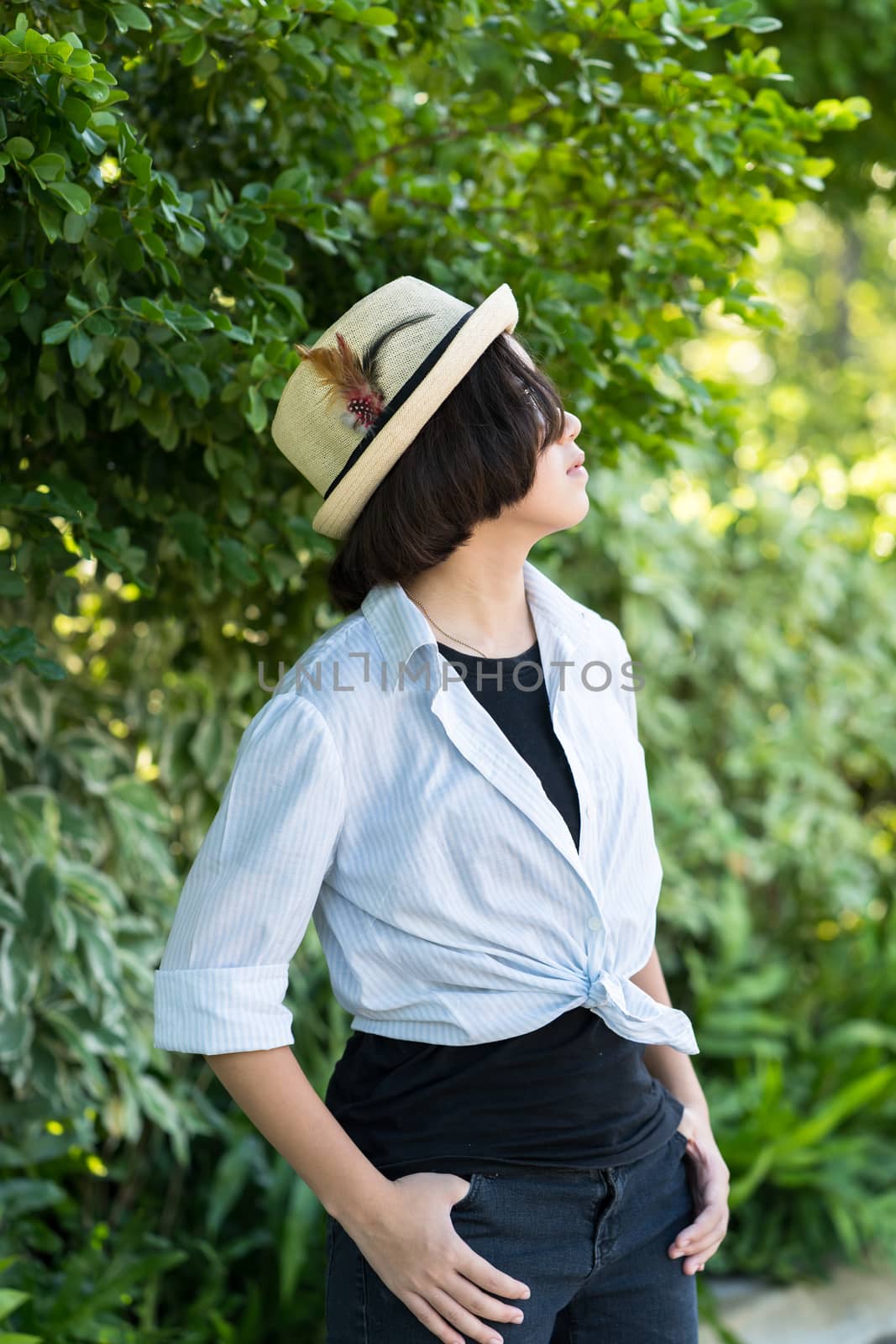 Beautiful and young women with short hair wearing hat in park