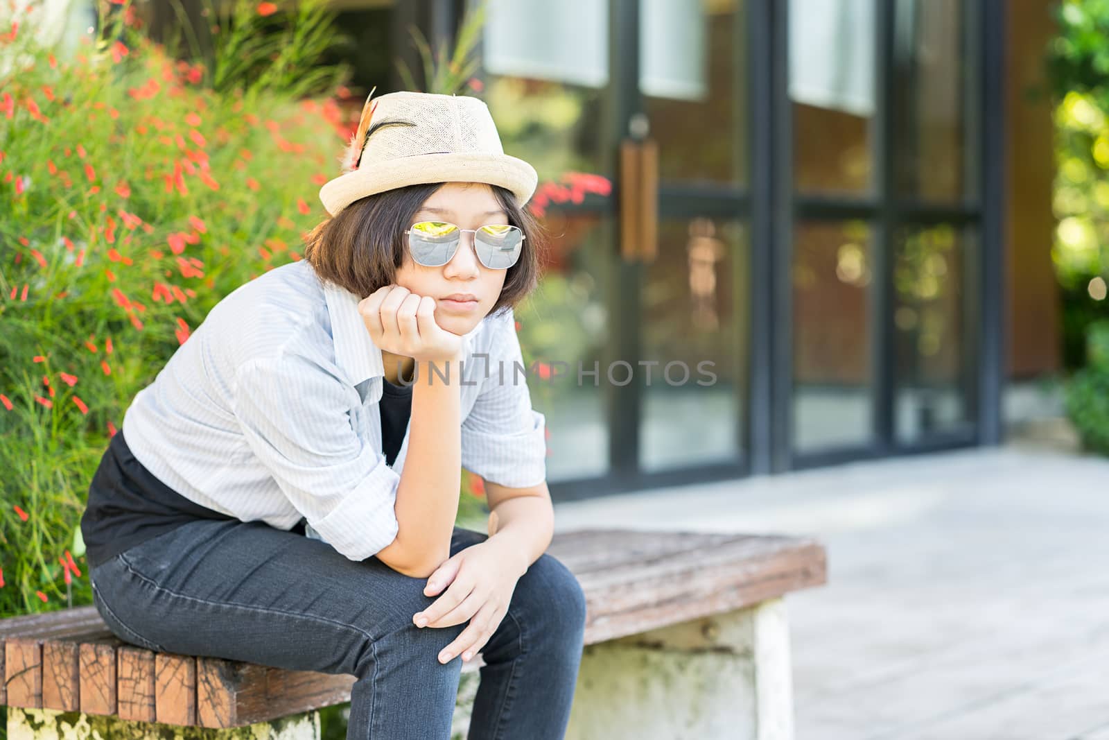 Beautiful and young women with short hair wearing hat in park