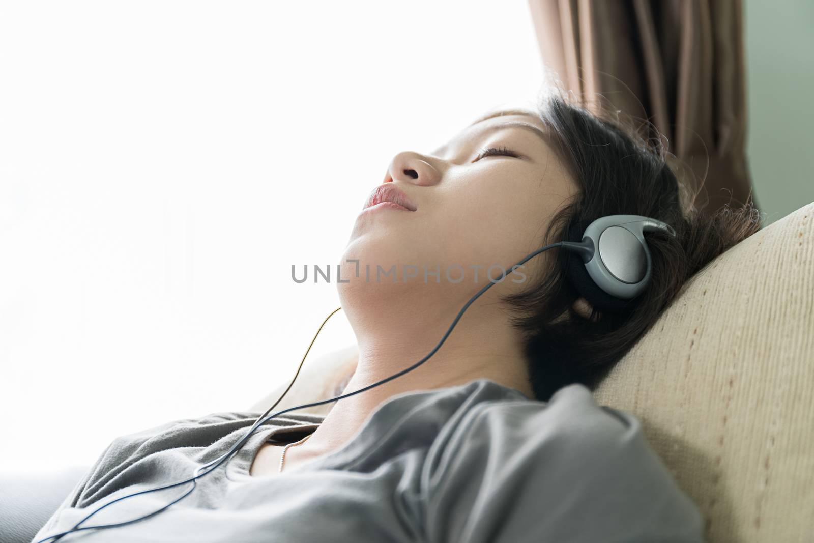 Young asian woman short hair listening music  by stoonn