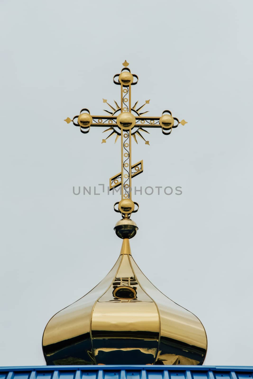 Orthodox church dome with cross on the sky background