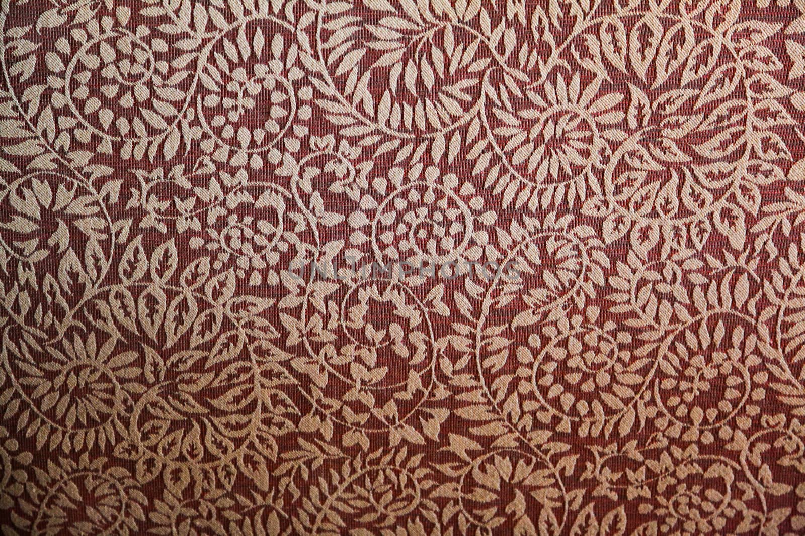 A white leaf like pattern on red fabric
