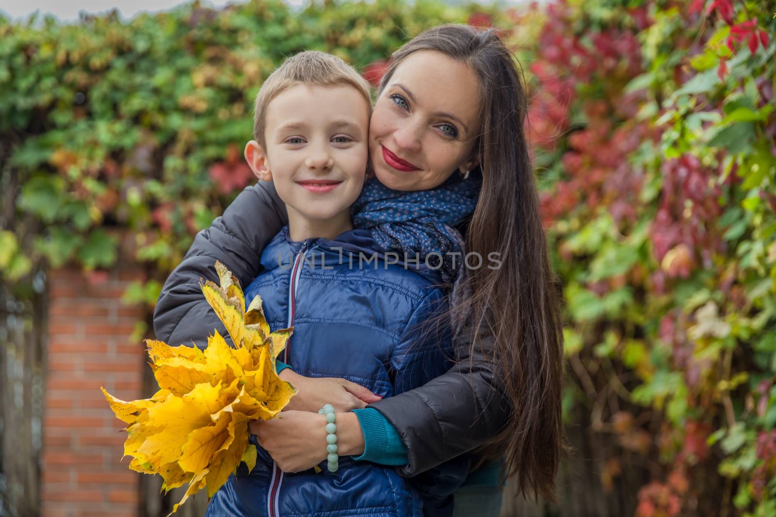 Mother and son hugging among autumn by Angel_a