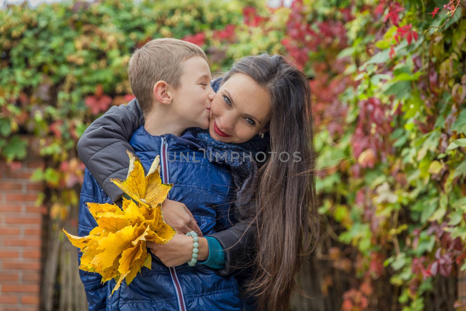 Son kissing mother among autumn by Angel_a