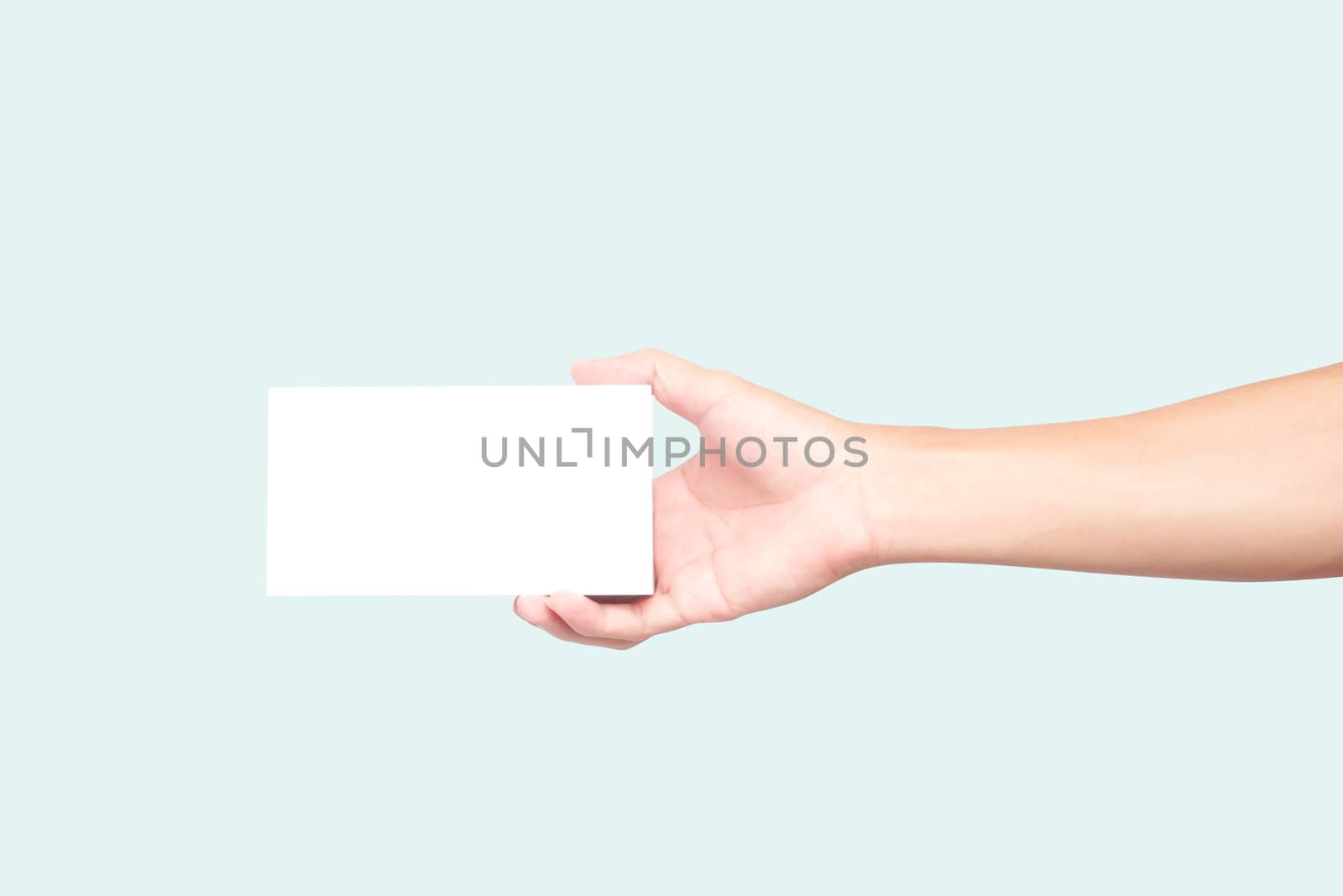 Man hand holding white box on light blue background for text or advertising concept 