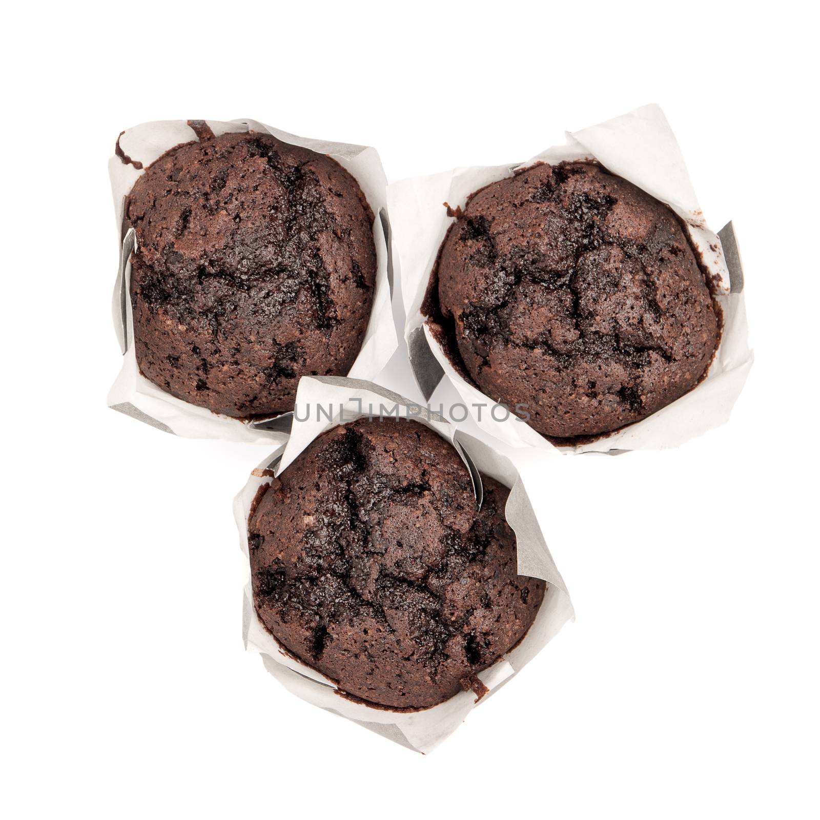 Closeup of a Magdalena Typical Spanish Chocolate Muffin. Sweet Food or Dessert. Three Fresh Baked Muffin Isolated on White Background in American Style. Irresistible Tasty Cake.